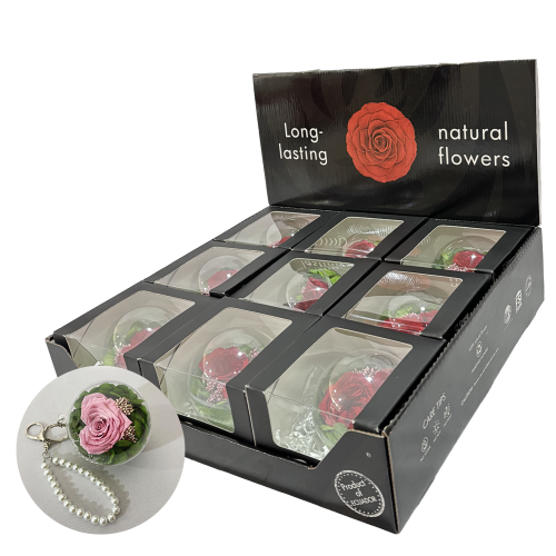 Display of black packaging boxes containing long-lasting natural roses, each with a clear window to view the arrangement.